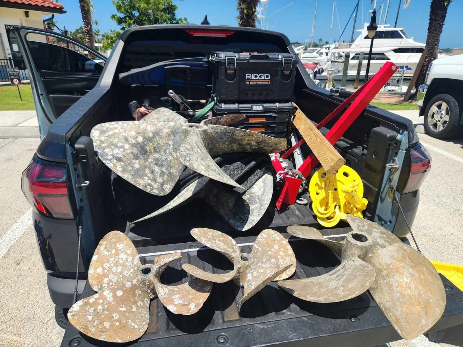 Large and small boat propellers loaded alongside Bottom Time's pulling equipment