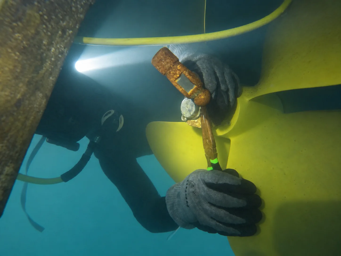 Diver servicing a boat propeller underwater